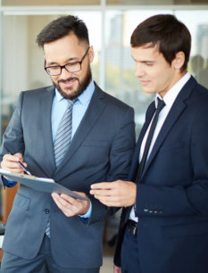 Employees looking at record book